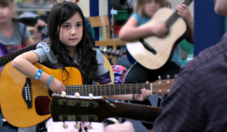 girl playing guitar